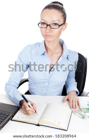 Businesswoman writing in daily planner book