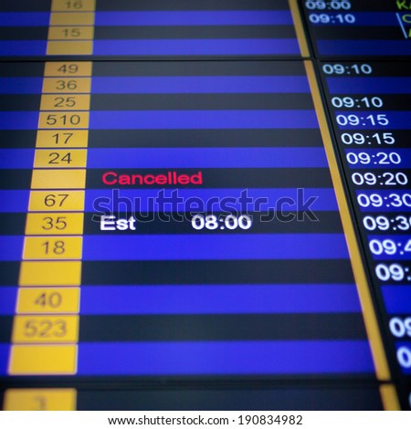 Airport arrival board in airport terminal. Flight cancelled.