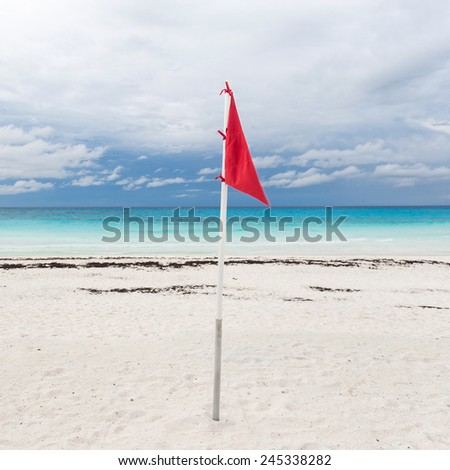 Lifeguard flag on caribbean beach, Cancun, Mexico