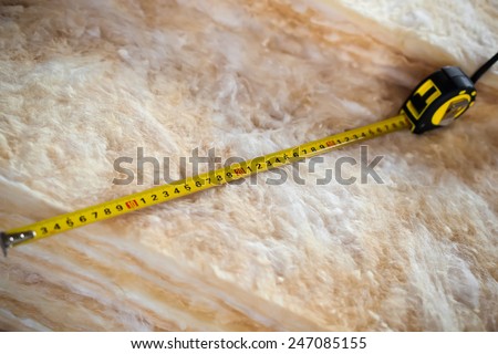 Measure tape on mineral wool, closeup