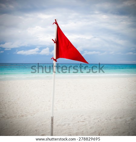 Lifeguard red flag at caribbean beach in bad weather