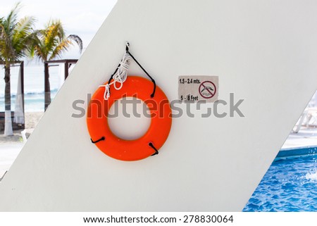Lifebuoy ring near swimming pool at luxury resort