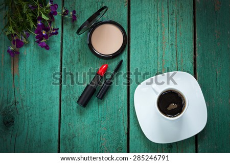 Make-up tools and morning cup of coffee, every day girls routine concept