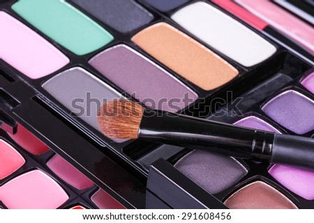 Make-up eye shadows palette with makeup brush, closeup