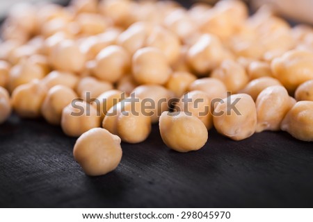 Raw wet gold chickpeas on wooden board, healthy vegan food with a lot protein, macro shot, selective focus