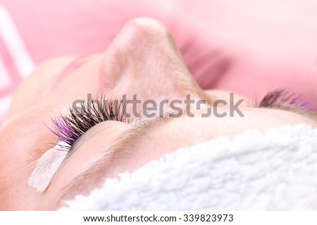 Lash making process, extreme long lashes with closed eye, woman eyelash extension. Macro shot, shallow depth