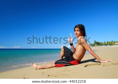 Man with  water in hand on beach