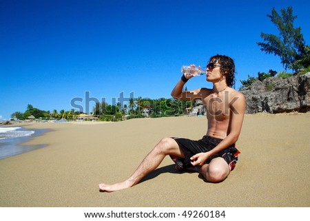 Man with water in hand on beach