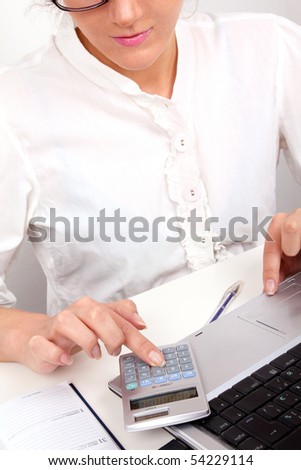 Businesswoman working in office, closed-up