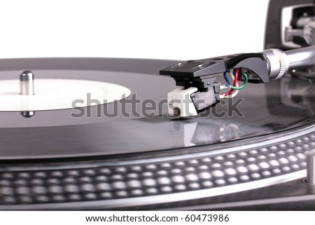 Dj needle on spinning turntable, closed-up on white