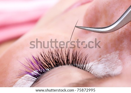 Lash making process, extreme long lashes and tweezers, close-up
