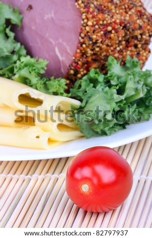 Bloated bacon,cheese and salad leaf on plate, closeup