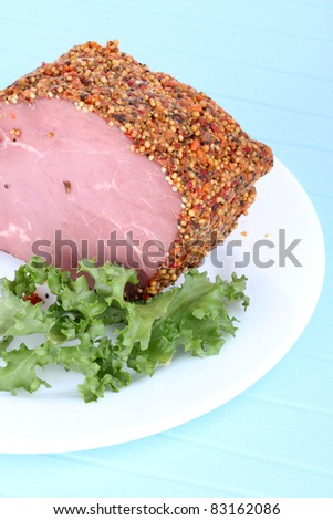 Bloated beef on white plate, closeup on blue background
