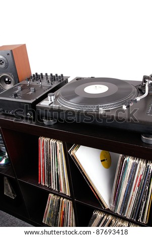 Turntable, mixer and loudspeaker on black table, closeup