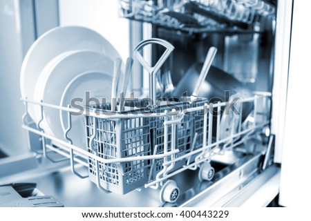 Open dishwasher with clean glass and dishes, selective focus