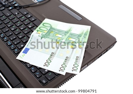 Euro on laptop, closeup om white