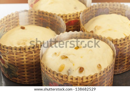 dough for the Easter cake in paper forms prepared for baking