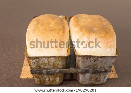 freshly baked bread in aluminum molds for baking