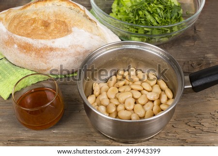 baked beans in a saucepan on the table from the old boards