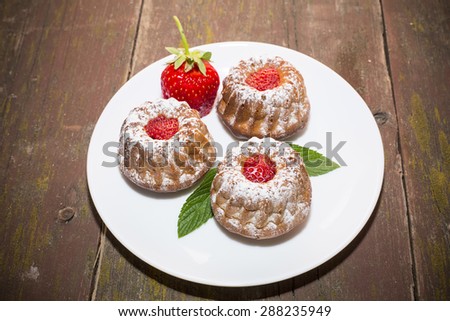 strawberry cupcakes on an old wooden table