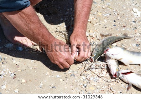 man-fisherman with a strong brown hands clinging caught fish
