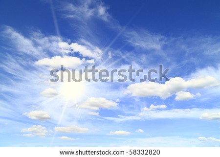 sun on the background of a beautiful sky with white clouds
