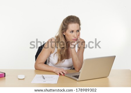 Image of a young female executive not able to concentrate on work, isolated on white background.