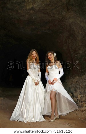 portrait on the two beauty brides on the cave entrance