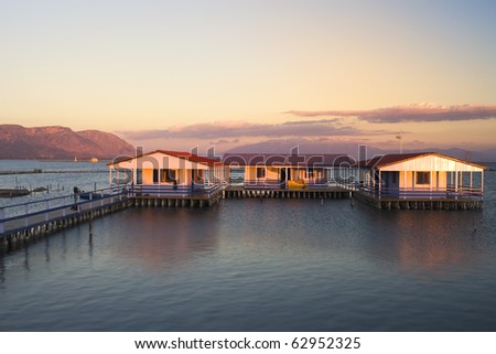 sunset over the water houses