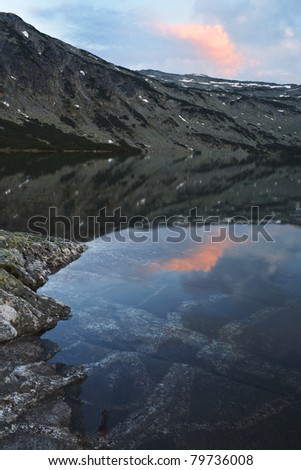 sunset reflection and underwater view of the mountain lake