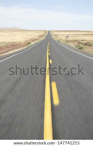 Motion blur of long hot desert highway in the USA