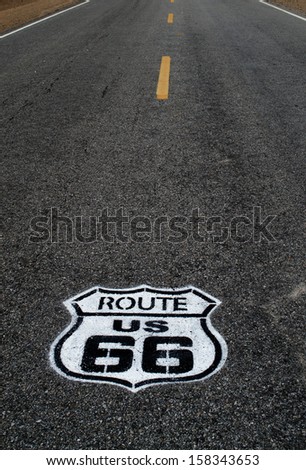 Route 66 pavement sign with Mojave desert