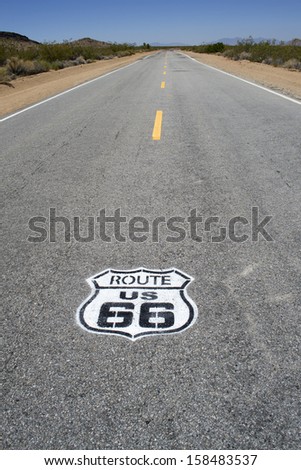 Famous historic Route 66 pavement sign with Mojave desert