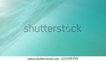 Sunbeams in blue deep sea or ocean underwater background