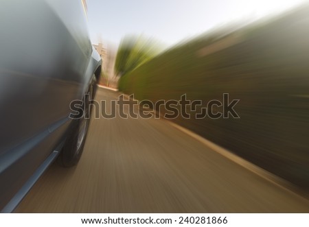 Front side view of a sport car in blurred motion