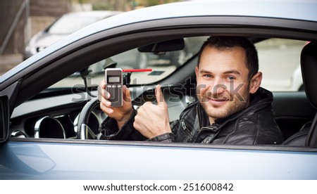 Happy young driver Man taking his alcohol test done passed, clear. showing thumbs up