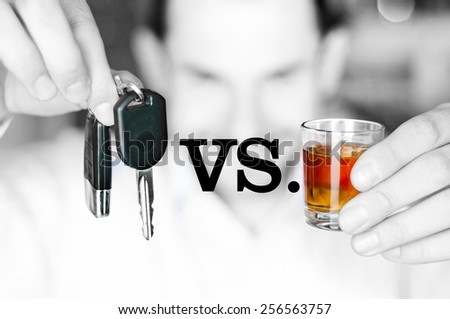 Alcoholic drink versus car keys in hands - do not drink and drive concept