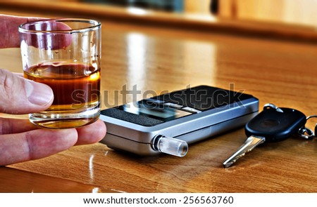 Alcoholic drink, breathalyzer and car keys - do not drink and drive concept