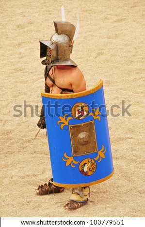 TARRAGONA, SPAIN - MAY 26: A gladiator on the arena of Roman Amphitheater on May 26, 2012 in Tarragona, Spain. Every year, the historic recreation program TarracoViva recreates a gladiators fight