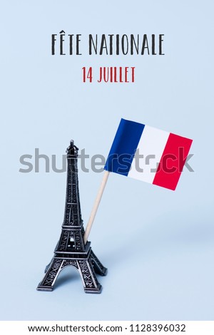 a miniature of the Eiffel Tower, a french flag and the text fete nationale 14 juillet, the national day of France written in French, against a pale blue background