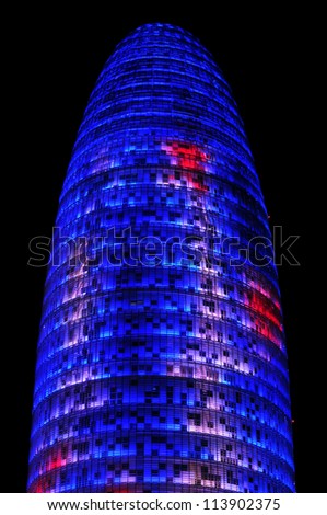 BARCELONA, SPAIN - AUGUST 15: Torre Agbar illuminated at night on August 15, 2012 in Barcelona, Spain. This 38-storey tower was designed by the famous architect Jean Nouvel