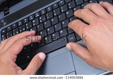 closeup of the hands of someone who is working with a laptop