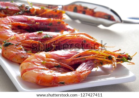 closeup of a plate with spanish shrimps cooked with garlic and parsley