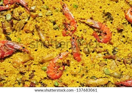 closeup of a typical paella mixta from Spain, with seafood and chicken