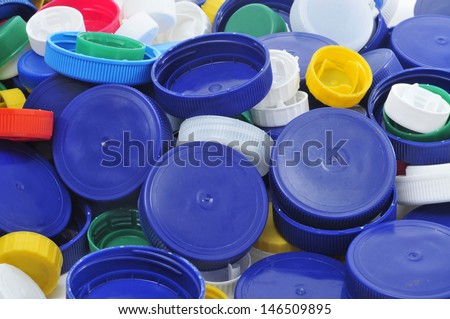 closeup of a pile of plastic screw caps of different colors and sizes