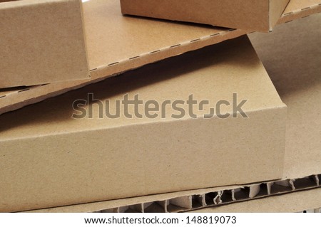 closeup of some brown cardboard boxes and some pieces of corrugated cardboard