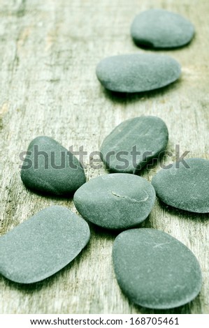 some stones forming a flower on an old wooden surface