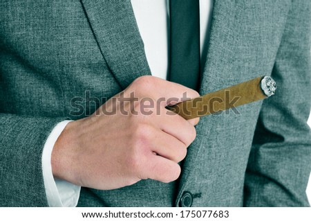 a man wearing a suit smoking a cigar