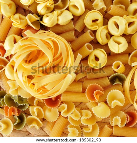a pile of different uncooked pasta, such as tortellini, tagliatelle or penne rigate