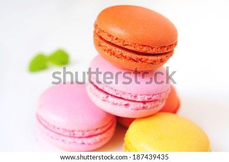 some appetizing macarons with different colors and flavors on a white background